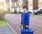 Portrait of Child with bored face holding plastic toy and carrying bag waiting for school bus, Unhappy Pupil of primary school loo