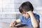 Portrait of Child boy playing playing game on mobile phone, Cute kid sitting outdoor cafe waching cartoons on cell phone while