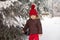 Portrait of child in brown jacket and red knitted hat and red tr