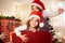 Portrait of a child at Christmas. Curly cute girl in santa hat a
