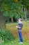 Portrait of child gathering colorful leaves in park