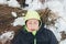 Portrait of a child lying on the snowy ground in the field, warmly dressed, enjoys the winter