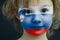 Portrait of a child with a painted Slovenian flag