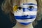 Portrait of a child with a painted Uruguayan flag