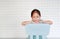 Portrait child preschool girl in a Kindergarten room poses on plastic baby chair