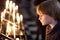 Portrait of a child standing by the burning candles