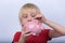 Portrait of child on white background with piggy Bank in hand. Boy puts coin into piggy Bank