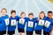 Portrait Of Children On Athletics Track Wearing Competitor Numbers On Sports Day