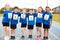 Portrait Of Children On Athletics Track Wearing Competitor Numbers On Sports Day