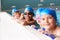 Portrait Of Children In Water At Edge Of Pool Waiting For Swimming Lesson