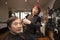 Portrait of chinese hairdresser cutting customer hair in salon