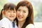 Portrait Of Chinese Mother With Daughter In Park