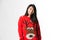 Portrait of Chinese woman in Christmas sweater standing in front of gray background