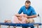 portrait of chiropractor massaging back of patient that lying on massage table