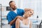 portrait of chiropractor stretching neck of woman