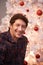 Portrait, Christmas and man with smile, home and happiness with decorations and festive season. Face, Xmas tree and