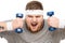 Portrait of chubby caucasian man yelling while holding dumbbells