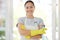 Portrait, cleaning and arms crossed with a woman housekeeper using disinfectant to remove bacteria in a home. Safety