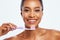 Portrait, cleaning and a black woman brushing teeth in studio isolated on a white background for oral hygiene. Face