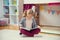 Portrait of clever little girl reading book at home