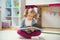 Portrait of clever little girl reading book at home