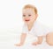 Portrait close up of cute baby crawling on the floor over white background