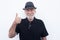 Portrait close-up of a smiling senior man with white beard on white background wearing a black hat and vest. Positive retiree