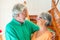 Portrait and close up of two happy seniors or mature and old people smiling and looking at the camera - couple of pensioners