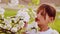 Portrait close-up, white-skinned boy in the spring garden. Caucasian boy in a lush garden in the spring.