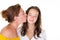 Portrait closeup two caucasian lovely women adult mother kissing on cheek her teenage daughter girl over white background