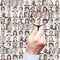 Portrait collage with business people being searched by hand with magnifying glass