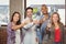 Portrait of colleagues toasting with champagne in office