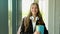 Portrait of an college girl student with books in hands in the university building. Back to school