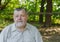 Portrait of comfortable senior man in light shirt