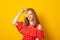 Portrait of comic happy girl holding halves of orange near face