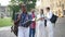 Portrait of concentrated African American woman standing at college campus learning with group of multiethnic groupmates