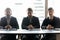 Portrait of concentrated businessmen sit at office desk together