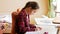 Portrait of concentrated girl doing homework in bedroom