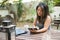 Portrait of concentrated Japanese woman using tablet at cafe