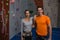 Portrait of confident athletes standing by climbing wall in gym