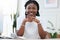 Portrait of confident black woman at desk with smile, notebook and online research for small business administration