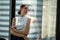 Portrait of confident businesswomen in office looking away by window