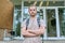 Portrait of confident college student guy, outdoor educational building