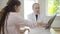 Portrait of confident doctor talking with patient showing lungs x-ray. Professional Caucasian man explaining radiograph