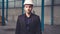 Portrait confident factory manager wearing suit and safety helmet