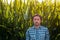 Portrait of confident farmer in tall green cornfield