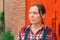 Portrait of confident female farmer in front of the farmhouse