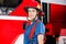 Portrait Of Confident Firewoman Wearing Red Helmet