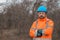 Portrait of confident forestry technician in woodland