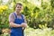 Portrait of confident gardener holding spade in plant nursery